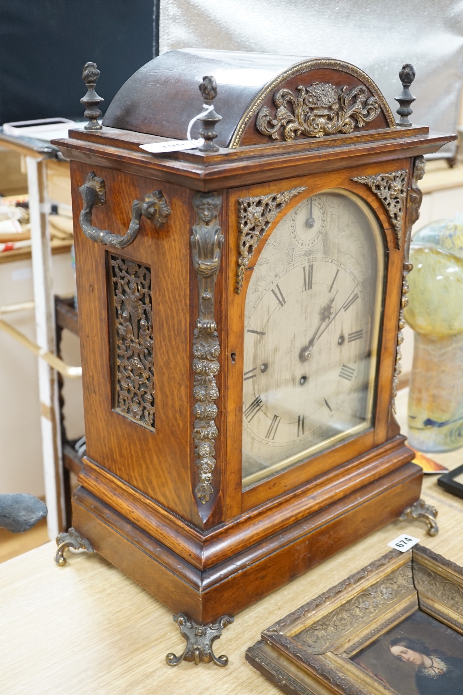 A late Victorian oak bracket clock with brass mounts and chiming movement, 55cms high